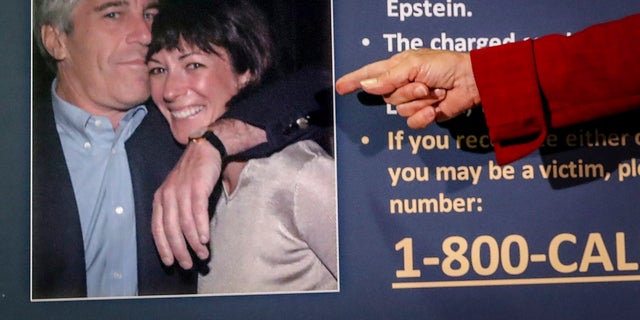 Audrey Strauss, acting U.S. attorney for the Southern District of New York, points to a photo of Jeffrey Epstein and Ghislaine Maxwell, during a news conference in New York. A judge on Thursday, Oct. 21, 2021, rejected British socialite Maxwell's bid to block the public and news media from jury selection in her New York City trial on charges she recruited teenage girls for financier Jeffrey Epstein to sexually abuse. (AP Photo/John Minchillo, File)