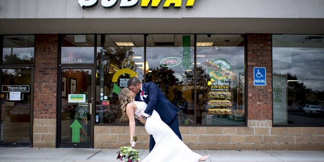 Julie Bushart and Zack Williams celebrated their first anniversary at Subway to commemorate their first meeting. Three years later got wedding photos taken in front of the restaurant where their love story began.