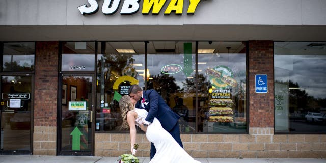 Julie Bushart and Zack Williams celebrated their first anniversary at Subway to commemorate their first meeting. Three years later got wedding photos taken in front of the restaurant where their love story began.