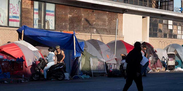 The tents of a homeless camp line the sidewalk in area commonly known as Mass and Cass, Oct. 23, 2021, in Boston.
