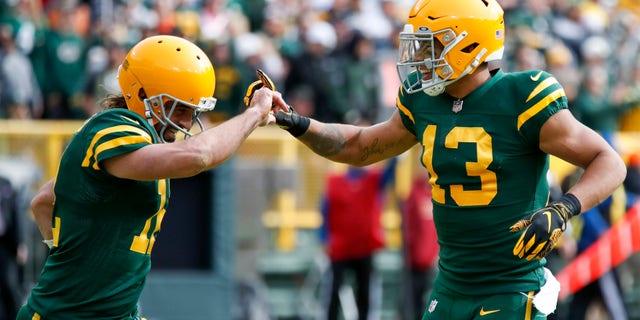 Green Bay Packers' Allen Lazard (13) celebrates his touchdown catch with Aaron Rodgers against the Washington Football Team Sunday, Oct. 24, 2021, in Green Bay, Wisconsin.