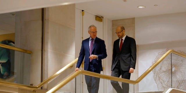 In this summer 2021 photo provided by CBS News, former senior Saudi security official Saad al-Jabri, right, walks with journalist Scott Pelley in Washington during an interview for "60 Minutes." (CBS News/60 Minutes via AP)