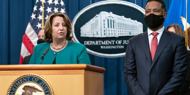 Deputy Attorney General Lisa Monaco, with Assistant Attorney General Kenneth Polite Jr. of the Justice Department's Criminal Division, speaks during a news at the Department of Justice in Washington, Tuesday, Oct. 26, 2021. Law enforcement officials in the U.S. and Europe have arrested 150 people and seized more than $31 million in an international drug trafficking investigation stemming from sales on the darknet. (AP Photo/Manuel Balce Ceneta)