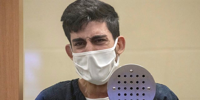 Ali Abulaban, 29, reacts during his arraignment, Monday, Oct. 25, 2021, at the San Diego Central Courthouse in San Diego. Abulaban, a TikTok star with nearly a million online followers, pleaded not guilty on Monday to shooting and killing his newly estranged wife and a man she was with last week at a San Diego high-rise. (Jarrod Valliere/The San Diego Union-Tribune via AP)