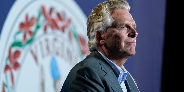 Democratic gubernatorial candidate Terry McAuliffe listens as President Joe Biden speaks Tuesday, Oct. 26, 2021, in Arlington, Virginia. (AP Photo/Alex Brandon)