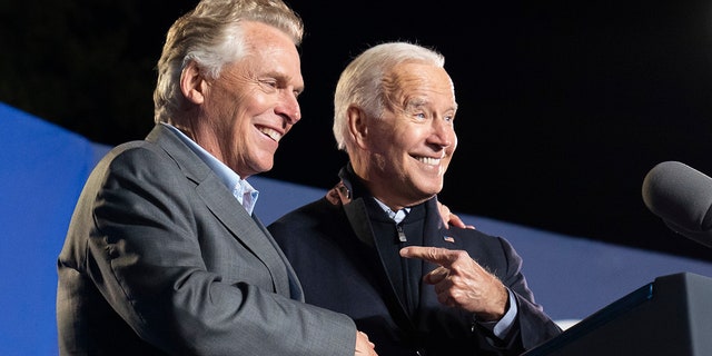 President Joe Biden, right, reacts after speaking at a rally for Democratic gubernatorial candidate, former Virginia Gov. Terry McAuliffe, Tuesday, Oct. 26, 2021, in Arlington, Va. McAuliffe will face Republican Glenn Youngkin in the November election. (AP Photo/Alex Brandon)