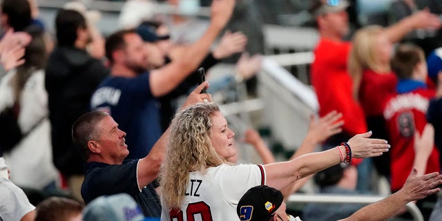 In this April 2021 file photo, Atlanta Braves fans do the Tomahawk Chop during a game against the Philadelphia Phillies in Atlanta.