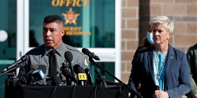 Santa Fe County Sheriff Adan Mendoza, left, speaks Santa Fe District Attorney Mary Carmack-Altwies, right, listens during a news conference in Santa Fe, New Mexico, Wednesday, Oct. 27, 2021. 