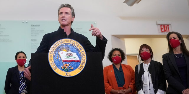 Gov. Gavin Newsom speaks at a news conference after receiving a Moderna COVID-19 vaccine booster shot at Asian Health Services in Oakland, Calif., Wednesday, Oct. 27, 2021. Also pictured are Assemblymember Mia Bonta, third from bottom right, Supervisor Wilma Chan and Oakland Mayor Libby Schaaf, right. (AP Photo/Jeff Chiu)
