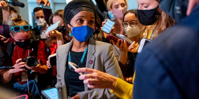 Rep. Ilhan Omar, D-Minn., speaks to reporters as she walks out of a House Democratic Progressive Caucus meeting on Capitol Hill in Washington, Thursday, Oct. 28, 2021.