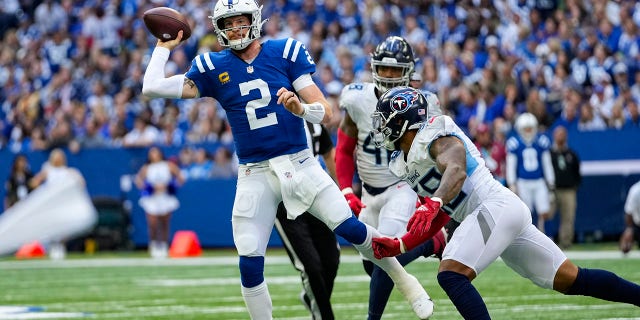 Indianapolis Colts quarterback Carson Wentz (2) throws under pressure from Tennessee Titans defensive end Jeffery Simmons (98) in the first half Sunday, Oct. 31, 2021. 