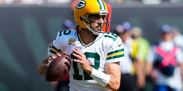 Green Bay Packers quarterback Aaron Rodgers (12) throws against the Cincinnati Bengals in the first half of an NFL football game in Cincinnati, Sunday, Oct. 10, 2021.