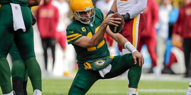 Green Bay Packers' Aaron Rodgers celebrates his first down run during the first half of an NFL football game against the Washington Football Team Sunday, Oct. 24, 2021, in Green Bay, Wis.