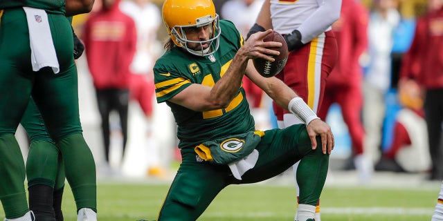 Green Bay Packers' Aaron Rodgers celebrates his first down run against Washington Sunday, Oct. 24, 2021, in Wisconsin.