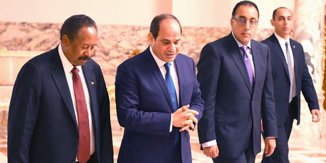 Sudanese Prime Minister Abdalla Hamdok (left) walks with Egyptian President Abdel Fattah al-Sisi (second from left) during their meeting at the Al Ittihadiyah Palace in Cairo, Egypt, on Sept. 18, 2019. (Photo by Egyptian Presidency / Handout/Anadolu Agency via Getty Images)