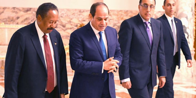 Sudanese Prime Minister Abdalla Hamdok, left, walking with Egyptian President Abdel Fattah al-Sisi (second from left) during their meeting at the Al Ittihadiyah Palace in Cairo, Egypt, in 2019.