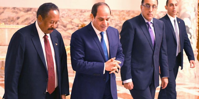 Sudanese Prime Minister Abdalla Hamdok (L) walks with Egyptian President, Abdel Fattah al-Sisi (2nd L) during their meeting at the Al Ittihadiyah Palace in Cairo, Egypt on September 18, 2019. (Photo by Egyptian Presidency / Handout/Anadolu Agency via Getty Images)