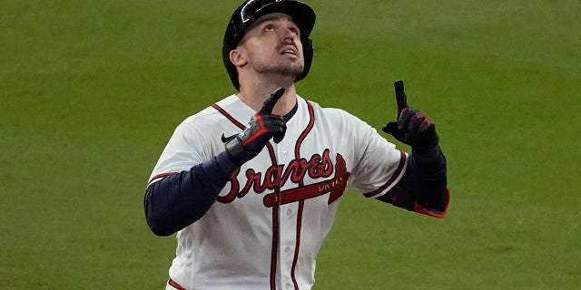 The Atlanta Braves' Adam Duvall celebrates his grand slam homerun during the first inning of Game 5 of the Baseball World Series between the Houston Astros and the Braves on Sunday, October 31, 2021 in Atlanta.