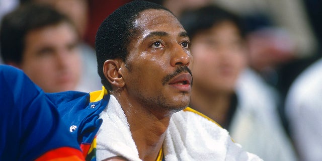 LANDOVER, MD - CIRCA 1990: Alex English #2 of the Denver Nuggets looks on from the bench against the Washington Bullets during an NBA basketball game circa 1990 at the Capital Centre in Landover, Maryland. English played for the Nuggets from 1980-90.