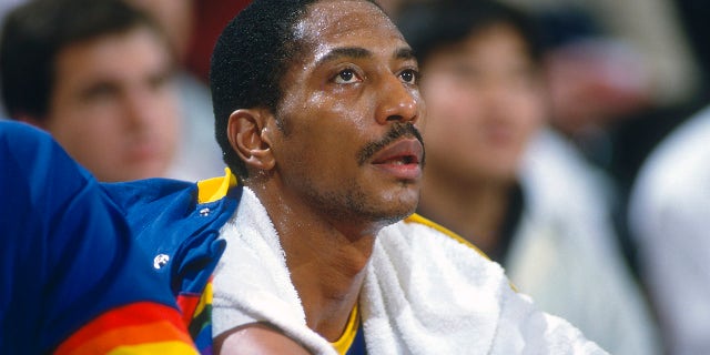 LANDOVER, MD - CIRCA 1990: Alex English #2 of the Denver Nuggets looks on from the bench against the Washington Bullets during an NBA basketball game circa 1990 at the Capital Centre in Landover, Maryland. English played for the Nuggets from 1980-90.