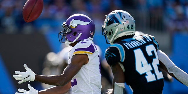 Minnesota Vikings long snapper Andrew DePaola (42) bobbles a punt return against Carolina Panthers safety Sam Franklin (42) during the second half of an NFL football game, Sunday, Oct. 17, 2021, in Charlotte, N.C.