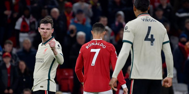 Liverpool's Andrew Robertson, left, gestures next to Manchester United's Cristiano Ronaldo at the end of the English Premier League soccer match between Manchester United and Liverpool at Old Trafford in Manchester, England, Sunday, Oct. 24, 2021. Liverpool won 5-0.