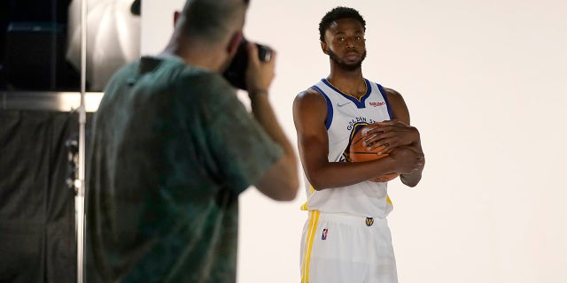 Golden State Warriors forward Andrew Wiggins, right, poses for photographer Noah Graham during NBA Basketball Team Media Day in San Francisco on Monday, September 27, 2021.