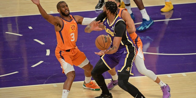 LOS ANGELES, CA - OCTOBER 22: Chris Paul #3 of the Phoenix Suns plays defense on Anthony Davis #3 of the Los Angeles Lakers on October 22, 2021 at STAPLES Center in Los Angeles, California.