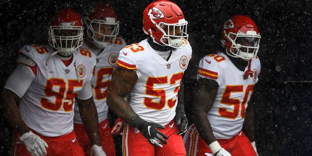 DENVER, CO - OCTOBER 25:  Kansas City Chiefs player run onto the field to warm up behind Anthony Hitchens #53 before a game against the Denver Broncos at Empower Field at Mile High on October 25, 2020 in Denver, Colorado.