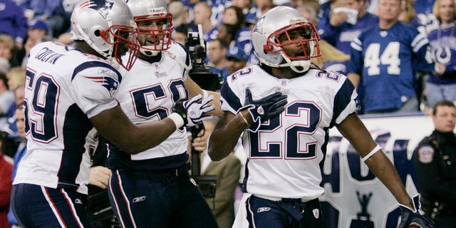 The New England Patriots' Asante Samuel (R) celebrates his touchdown in the second quarter after intercepting Indianapolis Colts quarterback Peyton Manning (not in photo) during the NFL's AFC Championship football game in Indianapolis, Jan. 21, 2007. The Patriots' Rosevelt Colvin (L) and Pierre Woods join the celebration. 