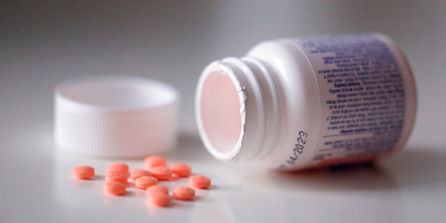 This Friday, Oct. 15, 2021 photo shows a bottle of aspirin in the Brooklyn borough of New York. (AP Photo/Emma H. Tobin)