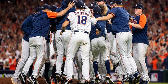 Members of the Houston Astros celebrate after defeating the Boston Red Sox in game six to clinch the 2021 American League Championship Series at Minute Maid Park on Oct. 22, 2021 in Houston, Texas.