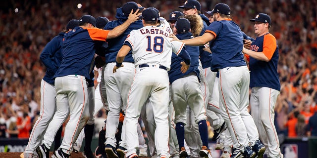 Members of the Houston Astros celebrate after defeating the Boston Red Sox in game six to clinch the 2021 American League Championship Series at Minute Maid Park on Oct. 22, 2021 in Houston, Texas.
