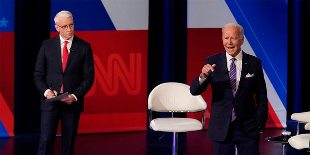 President Joe Biden participates in a CNN town hall at the Baltimore Center Stage Pearlstone Theater, Thursday, Oct. 21, 2021, in Baltimore, with moderator Anderson Cooper. (AP Photo/Evan Vucci)