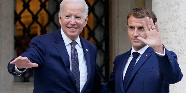 U.S. President Joe Biden, left, and French President Emmanuel Macron wave prior to a meeting at La Villa Bonaparte in Rome, Friday, Oct. 29, 2021.