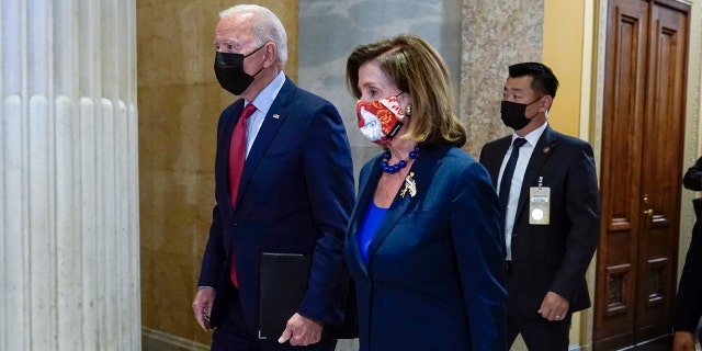 President Joe Biden walks with House Speaker Nancy Pelosi of Calif., on Capitol Hill in Washington, Friday, Oct. 1, 2021, for a meeting with the House Democratic caucus to try to resolve an impasse around the bipartisan infrastructure bill.