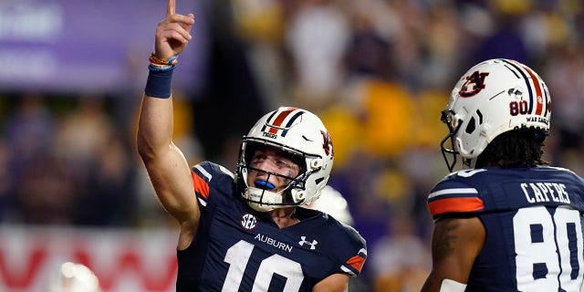 Auburn quarterback Bo Nix (10) celebrates after scoring a touchdown in the second half of an NCAA college football game against Auburn in Baton Rouge, La., Saturday, Oct. 2, 2021. Auburn won 24-19.