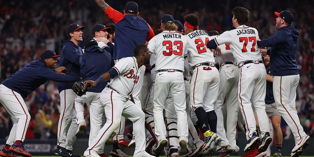 Members of the Atlanta Braves celebrate after defeating the Los Angeles Dodgers in Game Six of the National League Championship Series at Truist Park on October 23, 2021 in Atlanta, Georgia. The Braves defeated the Dodgers 4-2 to advance to the 2021 World Series. 