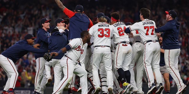 Members of the Atlanta Braves celebrate after defeating the Los Angeles Dodgers in Game Six of the National League Championship Series at Truist Park on October 23, 2021 in Atlanta, Georgia. The Braves defeated the Dodgers 4-2 to advance to the 2021 World Series.