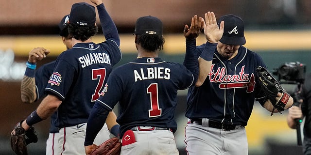 The Atlanta Braves celebrate their win against the Houston Astros in Game 1 of baseball's World Series between the Houston Astros and the Atlanta Braves Tuesday, Oct. 26, 2021, in Houston. The Braves won 6-2.