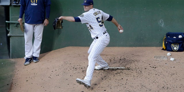 Jake Cousins (54) of the Milwaukee Brewers warms up in the bullpen in the fifth inning during Game 2 of the National League Division Series against the <a href=