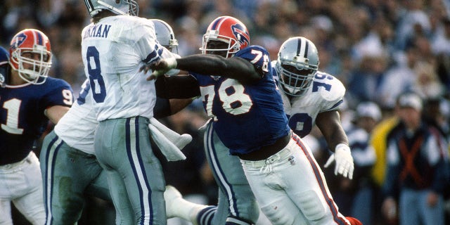 Troy Aikman of the Dallas Cowboys gets his pass off under pressure from Bruce Smith of the Buffalo Bills during Super Bowl XXVII on Jan. 31, 1993, in Pasadena, California. The Cowboys won, 52-17.
