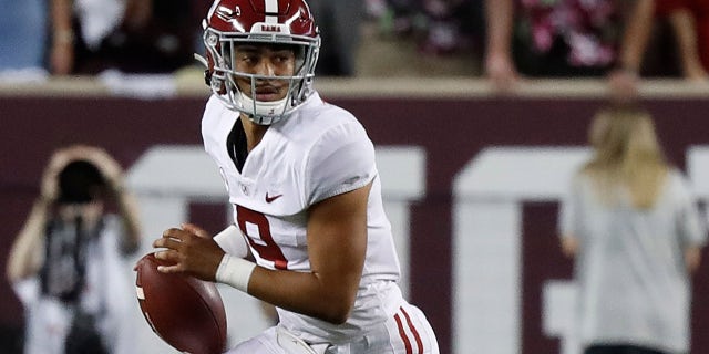 Bryce Young #9 of the Alabama Crimson Tide runs out of the pocket in the first half against the Texas A&amp;amp;M Aggies at Kyle Field on October 09, 2021 in College Station, Texas.