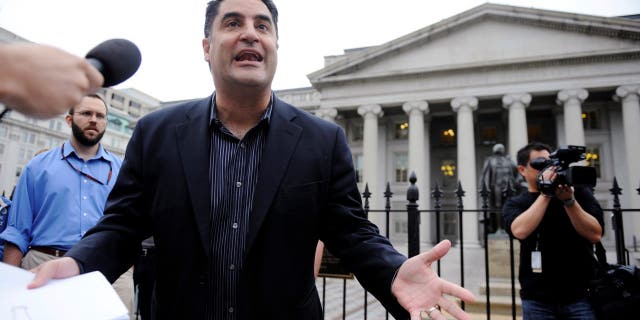 The Young Turks radio show host Cenk Uygur (C) leads a protest of government bailout money given to Goldman Sachs, with listeners gathered in front of the US Treasury building in Washington, June 9, 2010. REUTERS/Jonathan Ernst (UNITED STATES - Tags: POLITICS BUSINESS CIVIL UNREST ENTERTAINMENT)