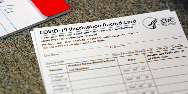 A COVID-19 vaccination record card is shown at Seton Medical Center in Daly City, Calif. (AP Photo/Jeff Chiu, File)
