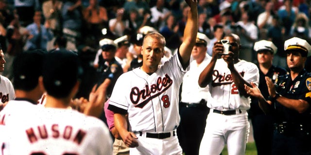 Infielder Cal Ripken Jr. of the Baltimore Orioles tips his cap to the fans after breaking Lou Gherig's record of 2,130 consecutive games played on Sept. 6, 1995, at Oriole Park at Camden Yards in Baltimore, Maryland.