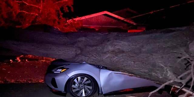 This early Monday, Oct. 11, 2021, photo provided by CalFire shows one of several vehicles damaged during a wind event in El Granada village in the coastal area of northern San Mateo County, California.
