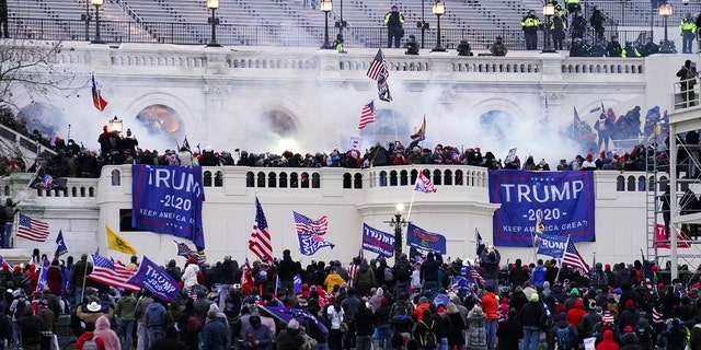 FILE - In this Jan. 6, 2021 file photo, violent protesters, loyal to President Do<em></em>nald Trump, storm the Capitol in Washington. A House committee tasked with investigating the Jan. 6 Capitol insurrection is moving swiftly to hold at least one of Do<em></em>nald Trump’s allies, former White House aide Steve Bannon, in contempt. That's happening as the former president is pushing back on the probe in a new lawsuit. (AP Photo/John Minchillo)