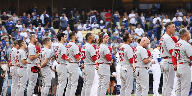 The St. Louis Cardinals line up for the pre-game ceremonies for the National League Wild Card Game between the St. Louis Cardinals and the Los Angeles Dodgers at Dodger Stadium on October 6, 2021 in Los Angeles, California.