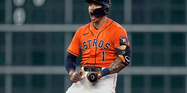 Houston Astros shortstop Carlos Correa celebrates after hitting a two-run double against the Chicago White Sox during the seventh inning in Game 2 of the American League Division Series Friday, Oct. 8, 2021, in Houston.